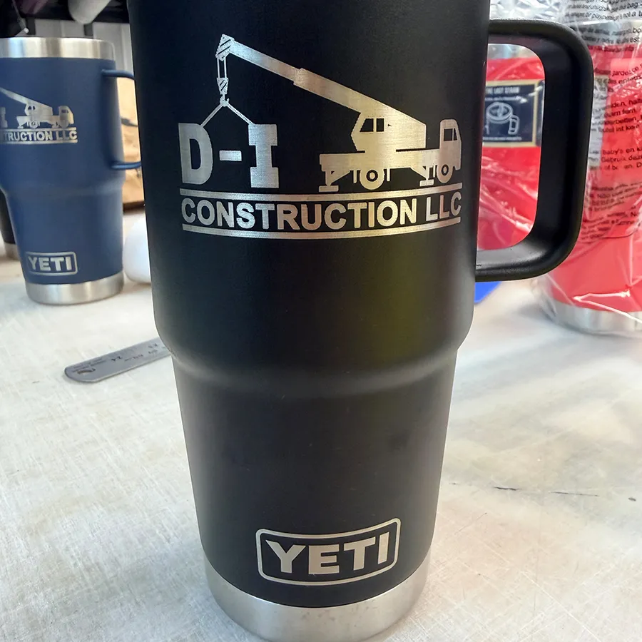 Black YETI tumbler with laser engraved D-I Construction crane logo