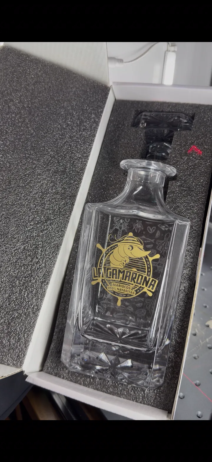 Glass decanter with a large custom illustration engraved across the face