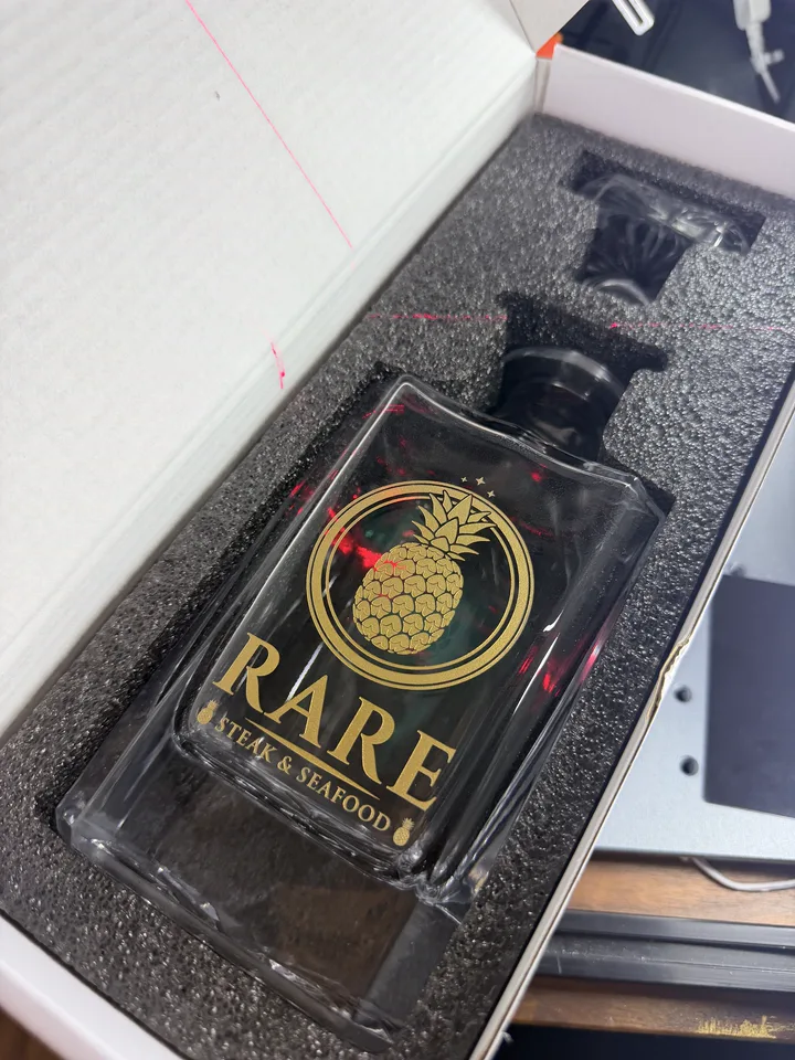 Glass decanter engraved with a fine-detail restaurant logo by Victory Laser Co