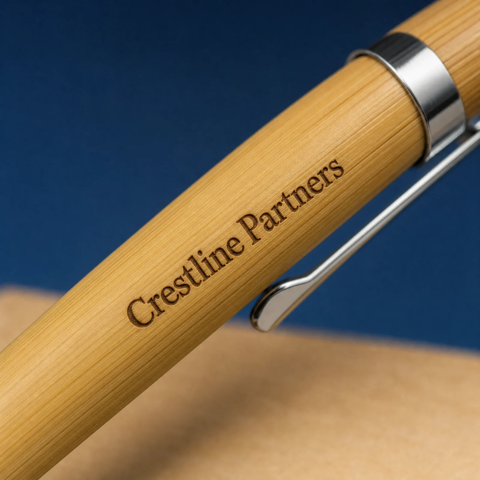 Close view of dark laser-engraved lettering on a bamboo pen barrel